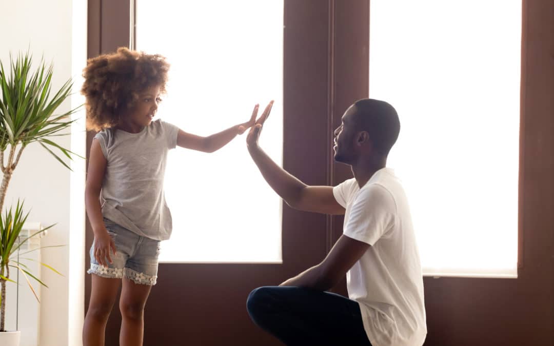 A father giving his daughter a high-five