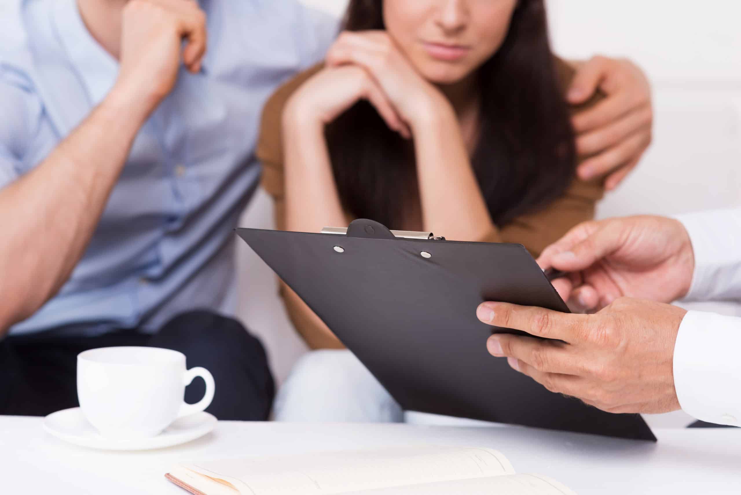 LawyerWithFamily Lawyer holding clipboard for couple