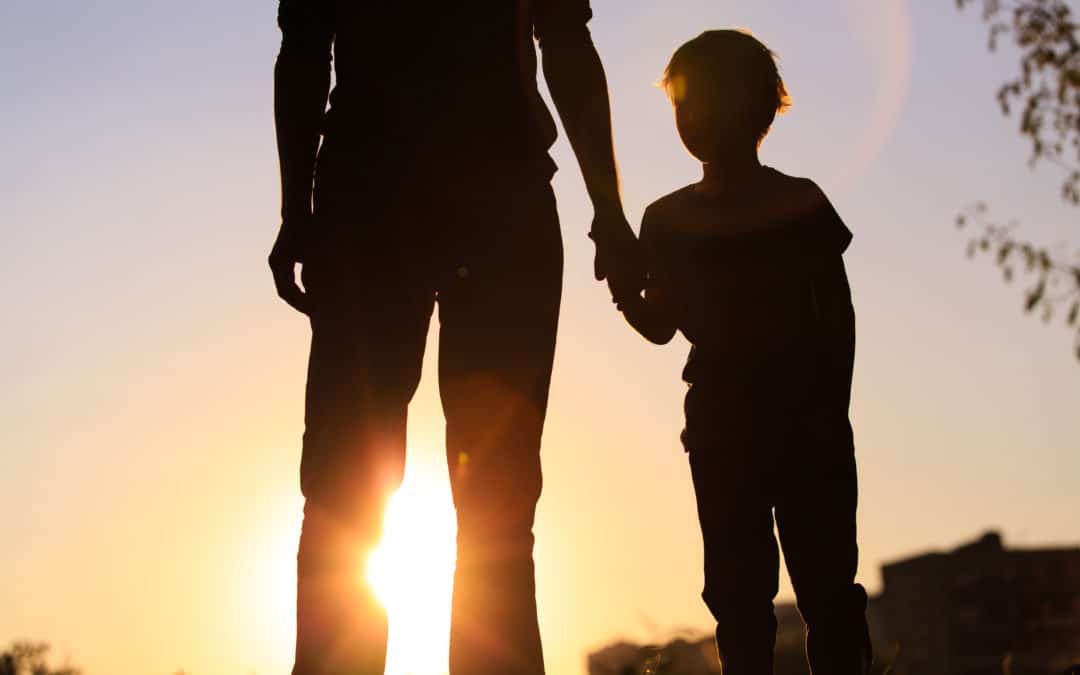 Silhouette of a parent with a little boy