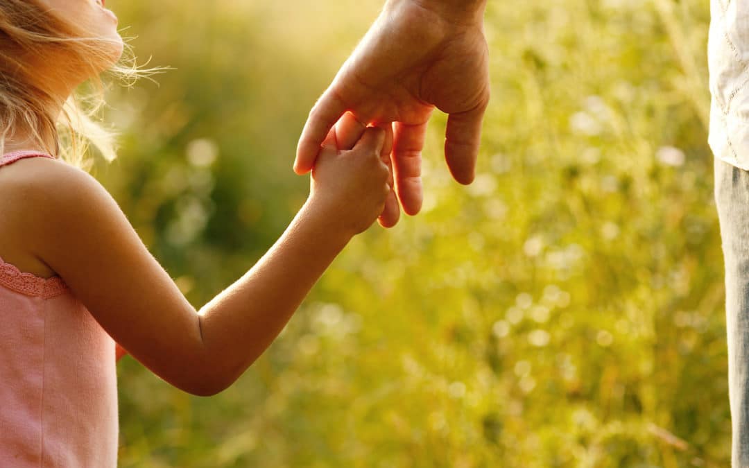 A child holding parents hand