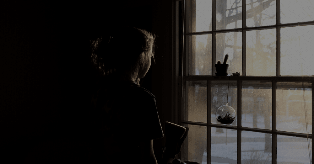 A young woman looking out a window