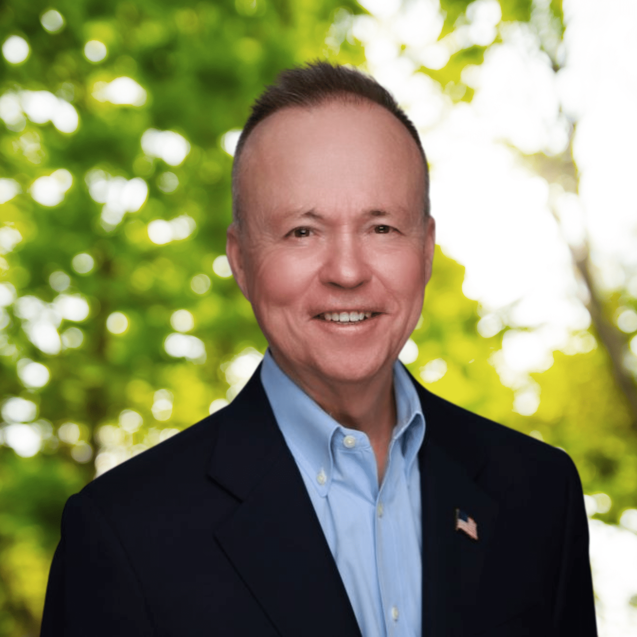 A male professional wearing a suit and tie